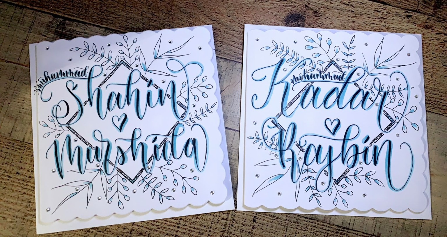 Pair of personalised hand-lettered cards with blue botanical details.